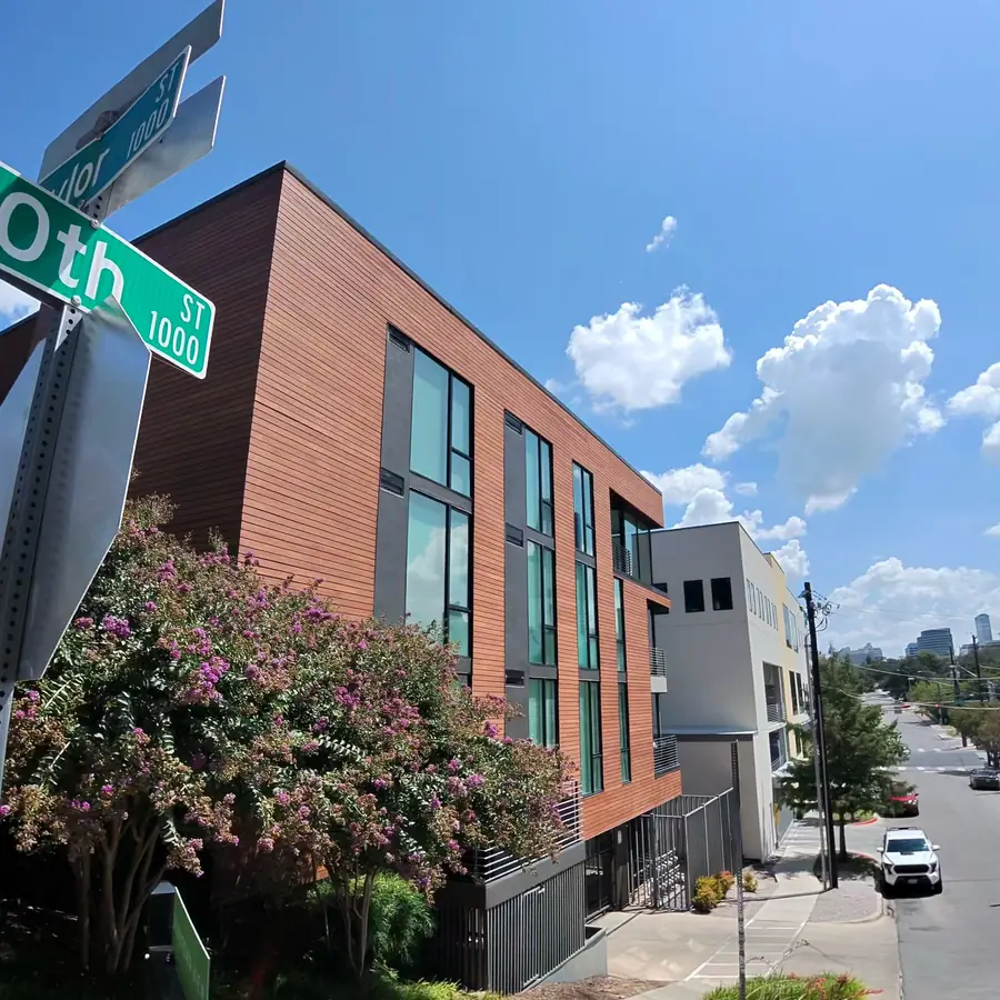 Modern wood clad building on a central Austin street, glass clean throughout