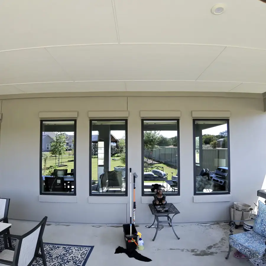 Covered patio with a bank of windows looking out onto the yard