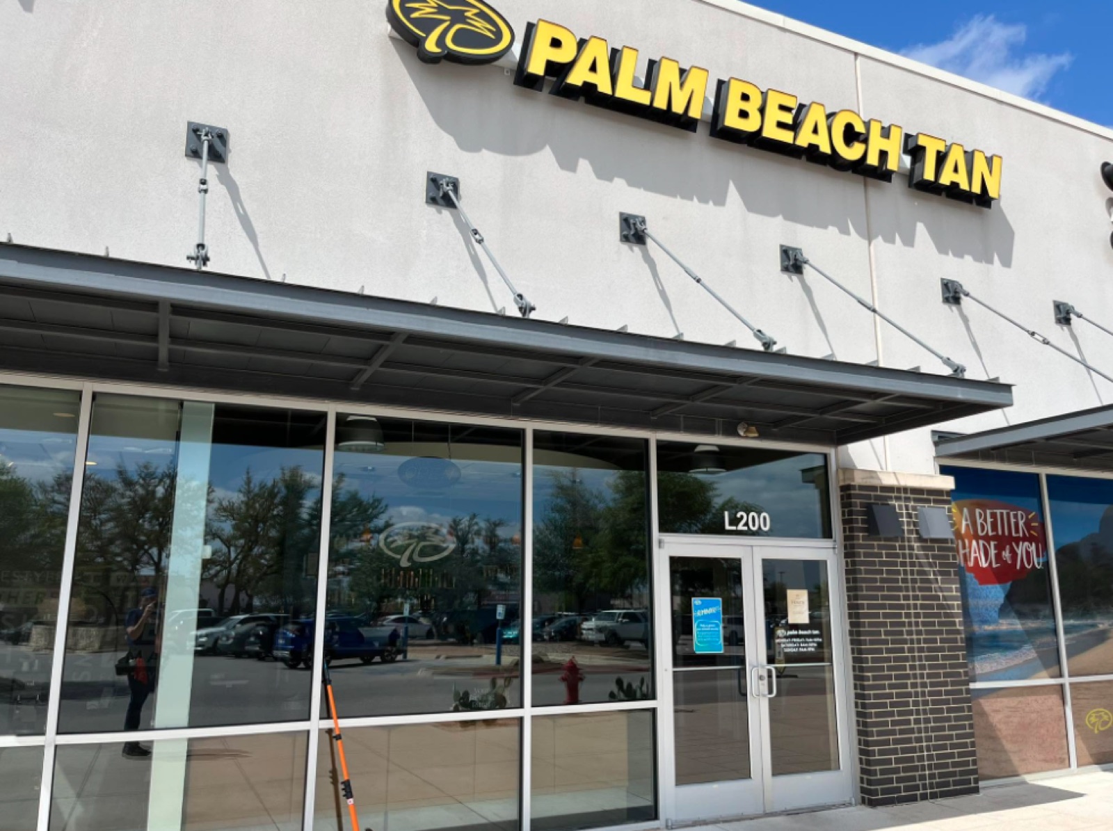Commercial storefront window cleaning at Palm Beach Tan