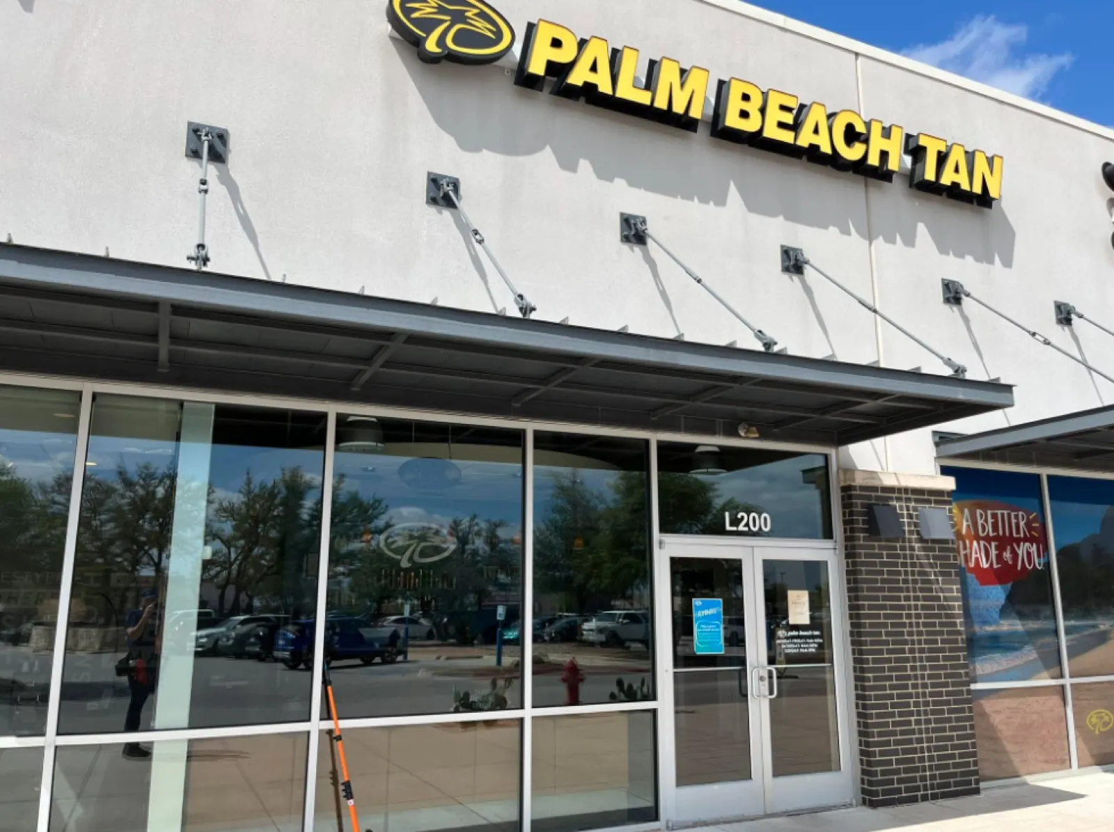 Commercial storefront window cleaning at Palm Beach Tan